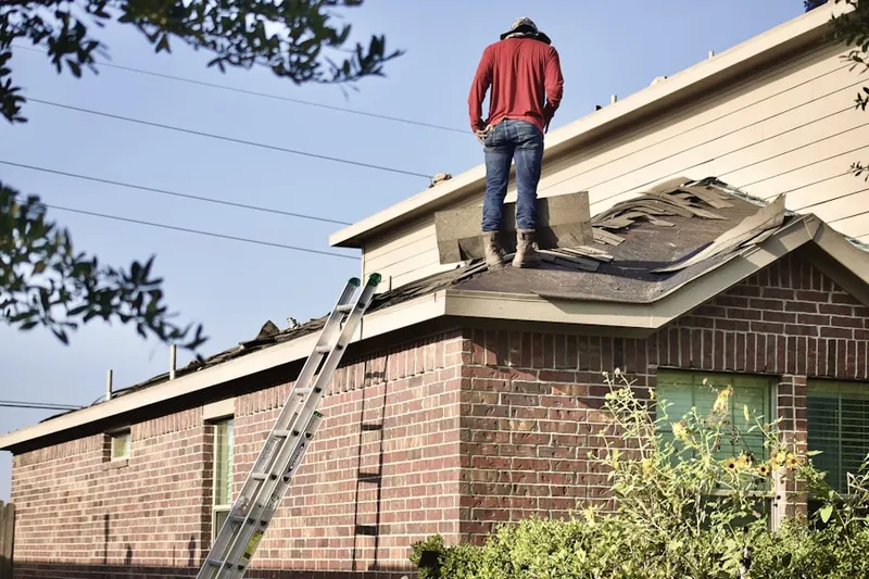 Professional roofer working on a residential roof in Rialto